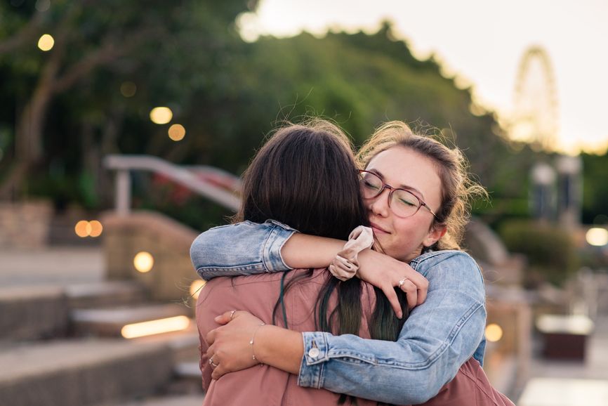 Two teenage girls hugging