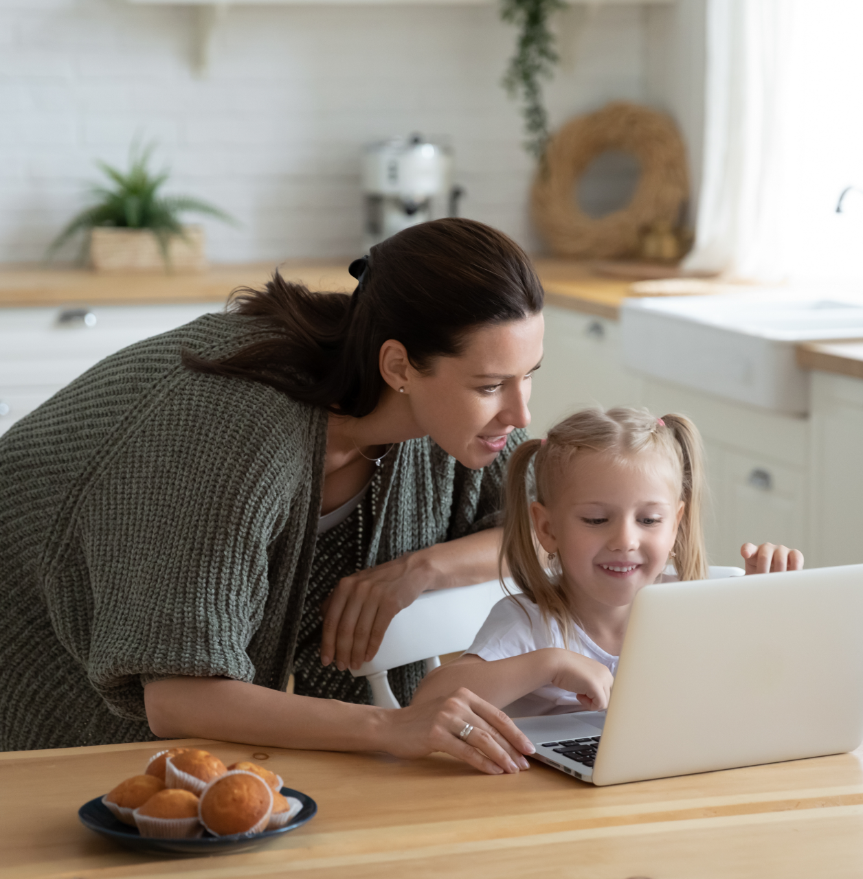 Mother and daughter using laptop